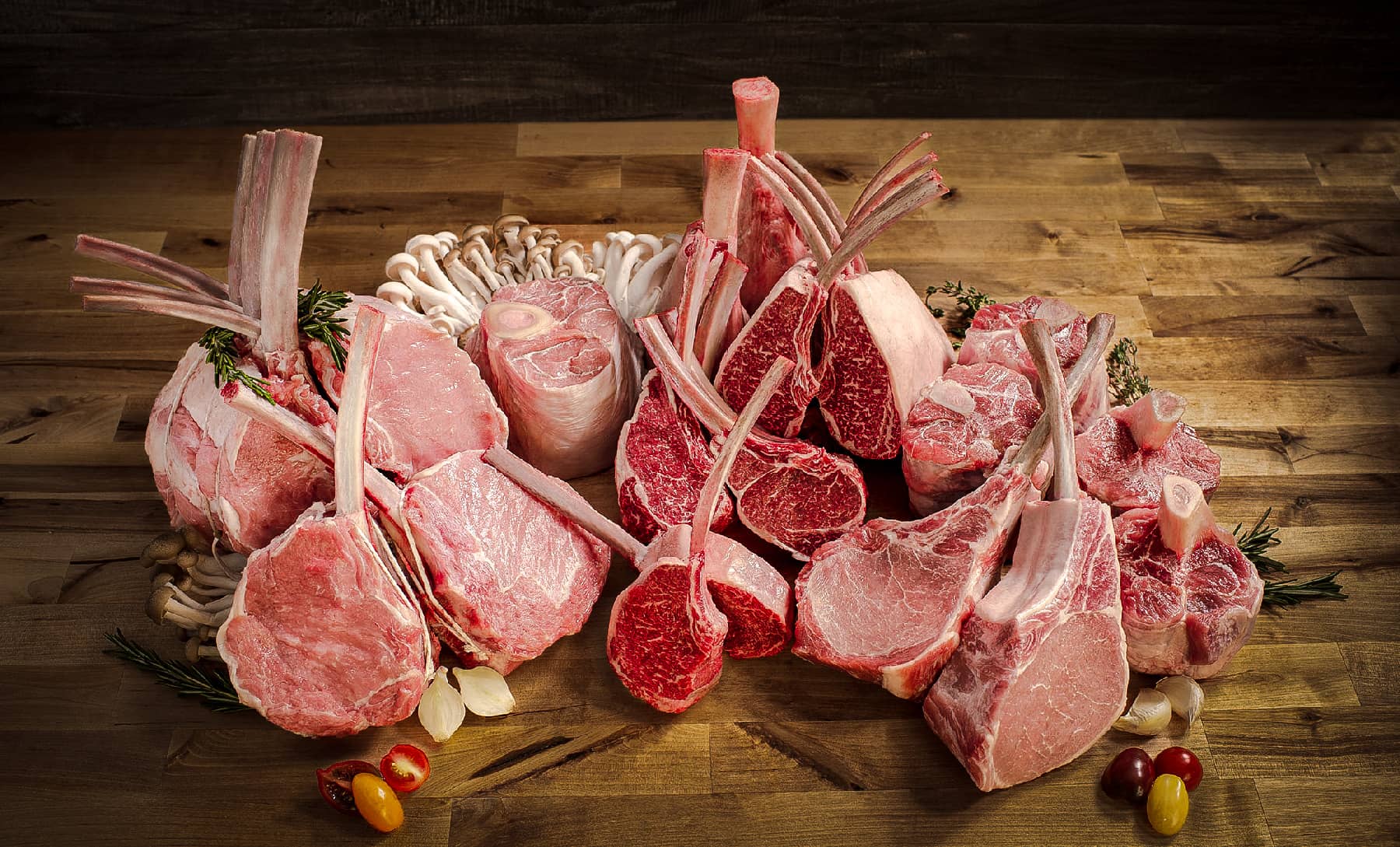 Variety of cuts of beef, pork, lamb, and veal with mushrooms.
